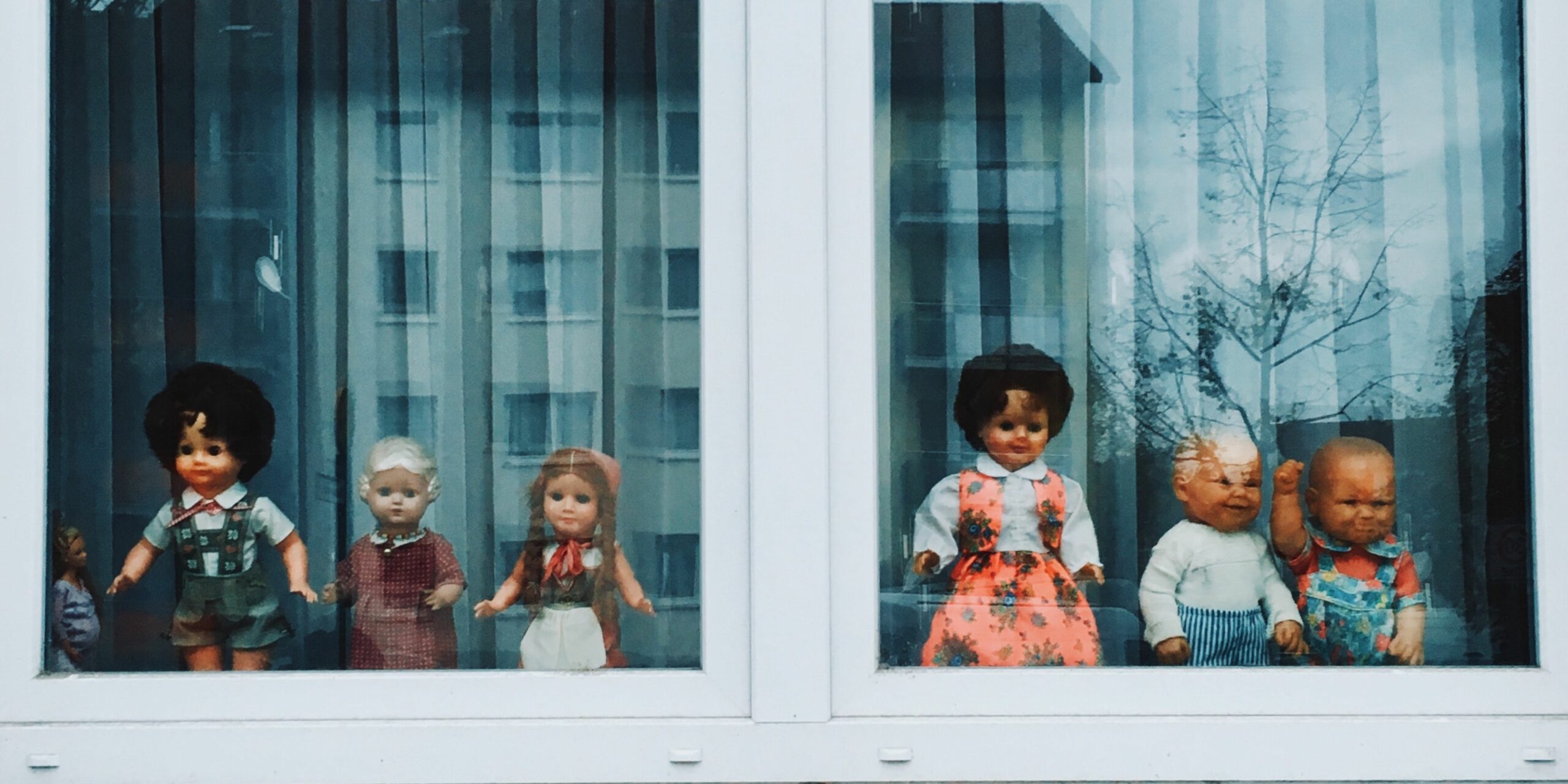 vintage dolls sitting on window